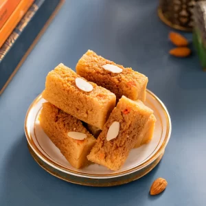 Assorted fresh Indian milk sweets including rasgulla, peda, and kalakand