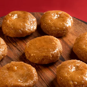 Assorted fresh Indian milk sweets including rasgulla, peda, and kalakand